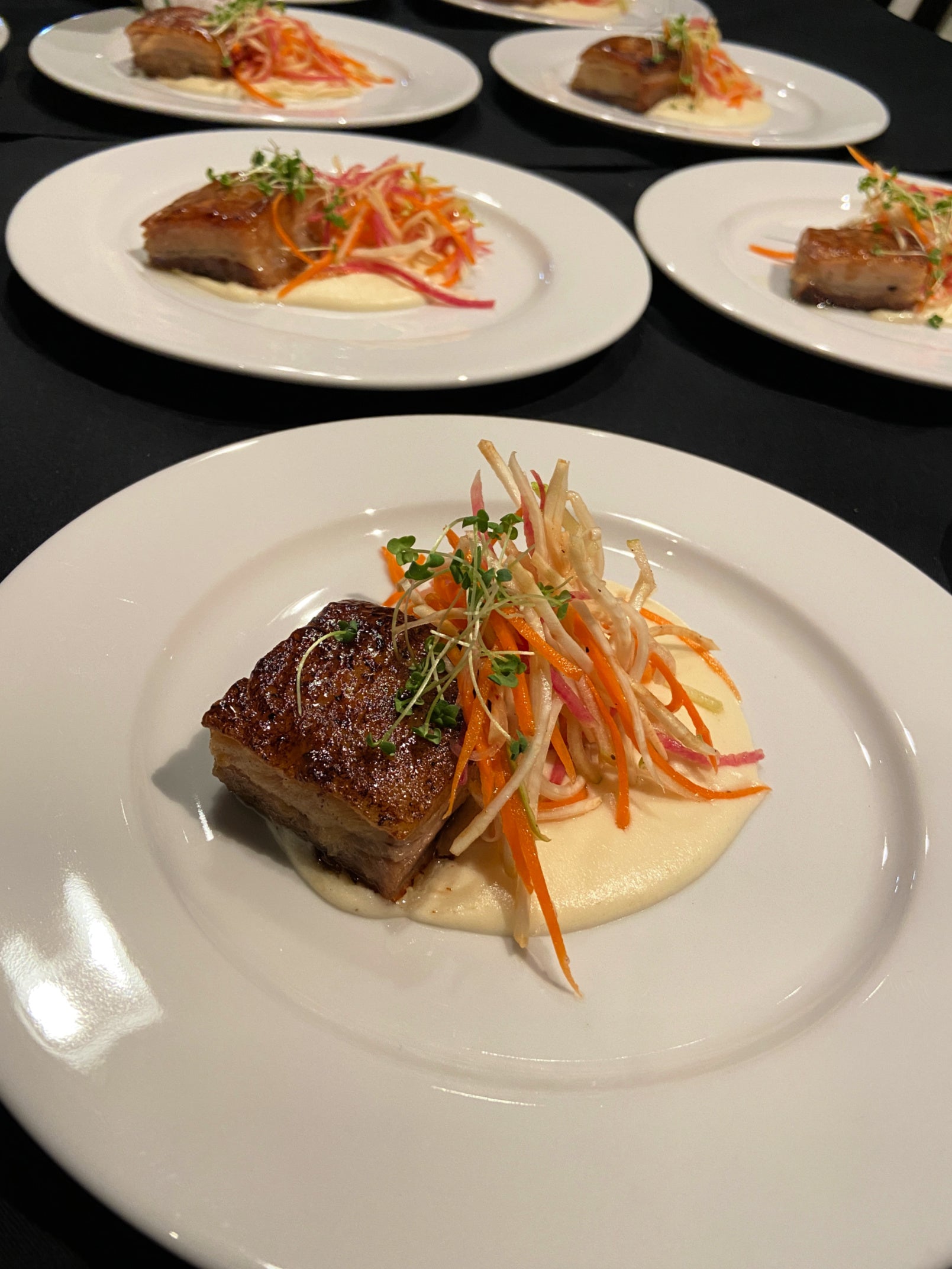 Crispy pork belly entrée with seasonal slaw served by Shef Madres Catering in Sacramento.